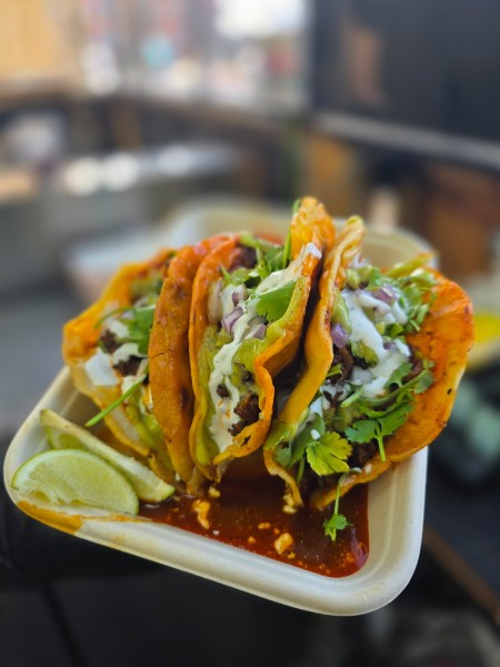 Three birria tacos with onion, cilantro and lime, served with consomé.